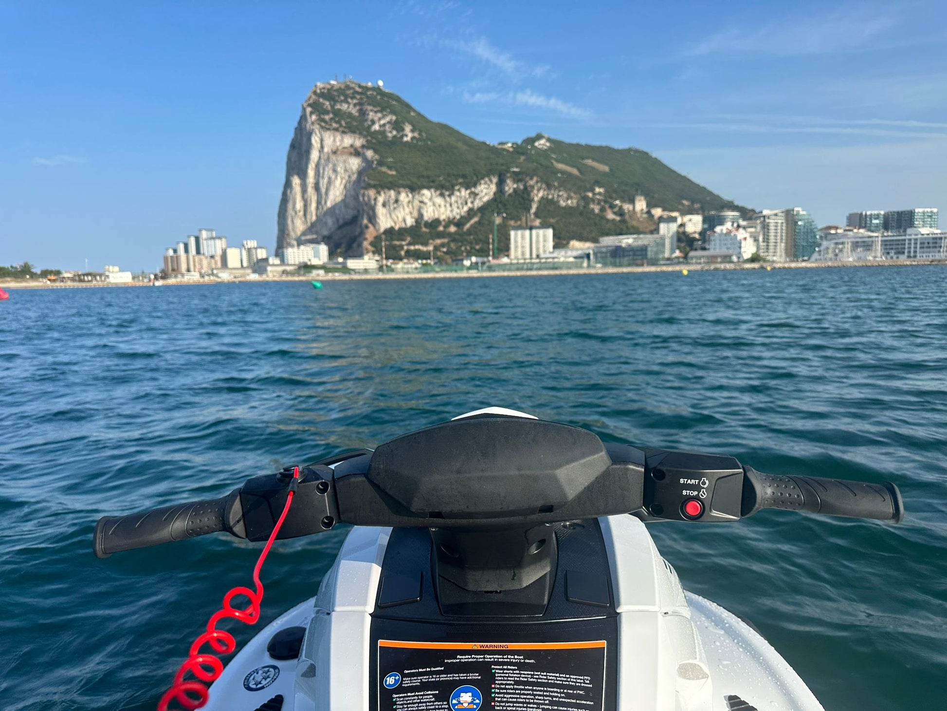Watersports vehicle on water with Gibraltar rock in the background