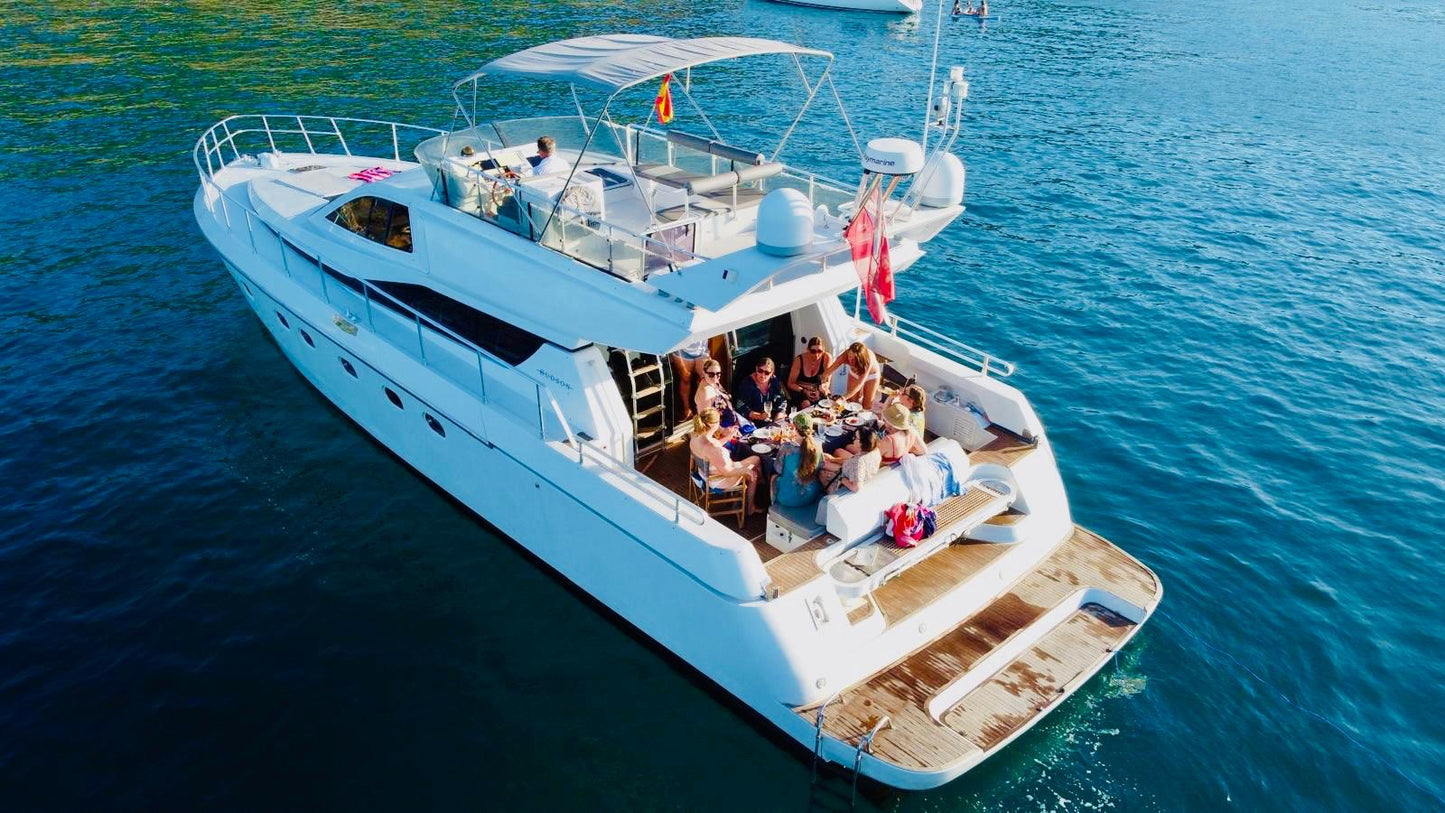 Yacht on the water with people enjoying a meal.
