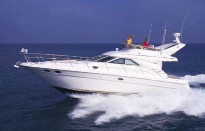 White yacht on the ocean with two people on board