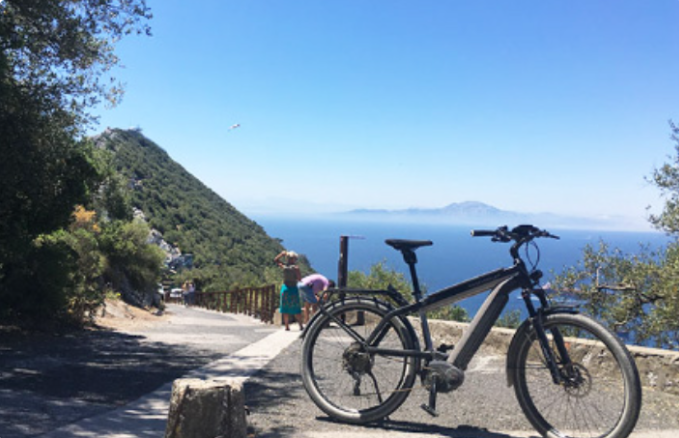 ebike on a scenic road in Gibraltar  with a view of the sea and Morocco.