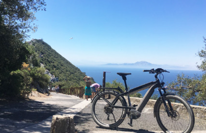 ebike on a scenic road in Gibraltar  with a view of the sea and Morocco.
